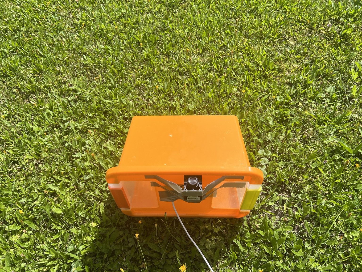 Close view of the laser mounted to the orange equipment case